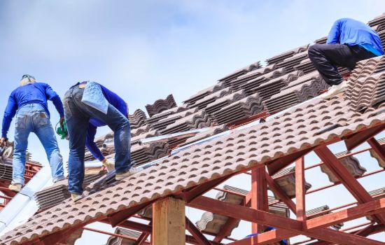Roof installation team working on a tiled roof
