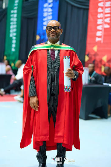 Academic portrait in red gown at DUT ceremony