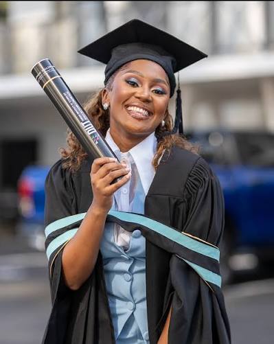 Graduate smiling with diploma tube