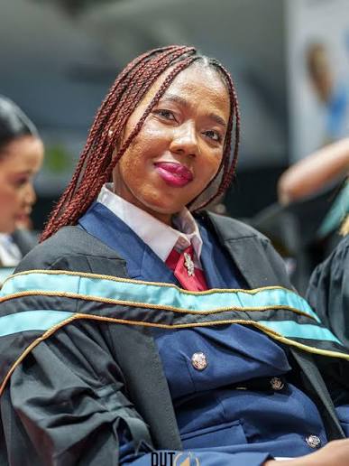 Seated graduate portrait during ceremony