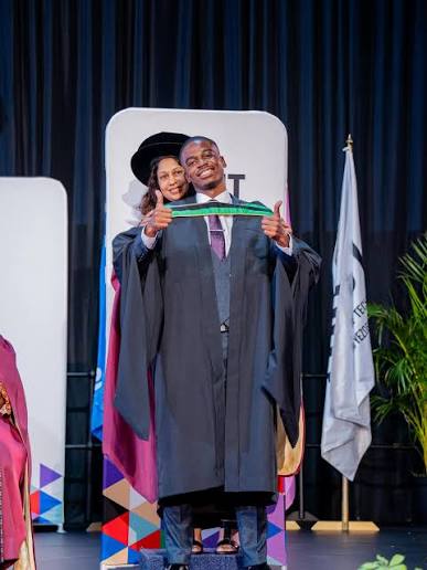 Graduate standing on ceremony stage