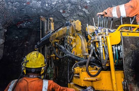 Underground mine drilling machinery and workers